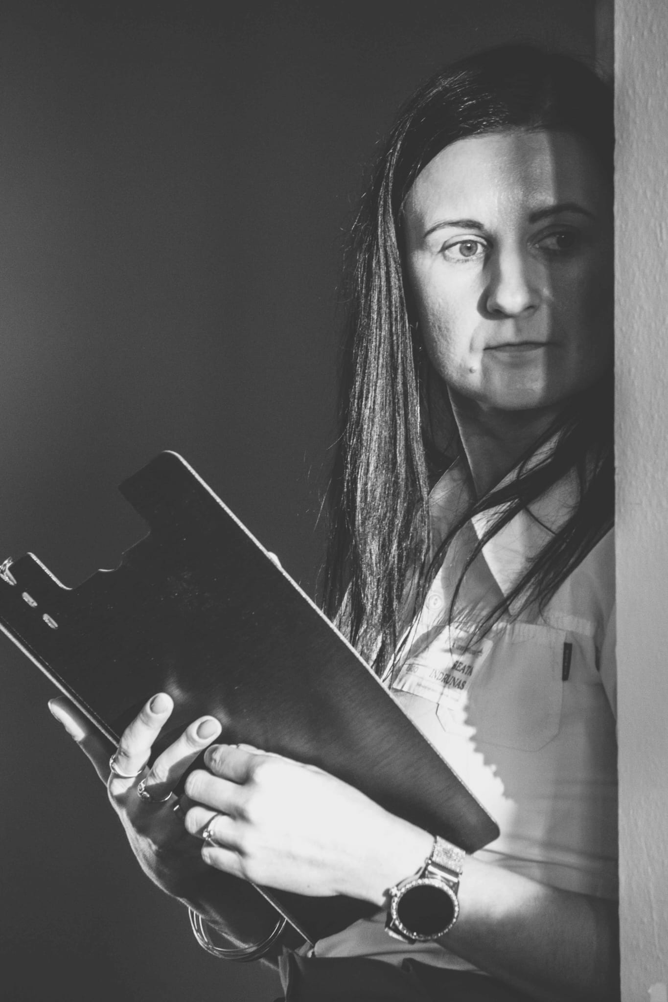 Beata with a  notebook against a wall